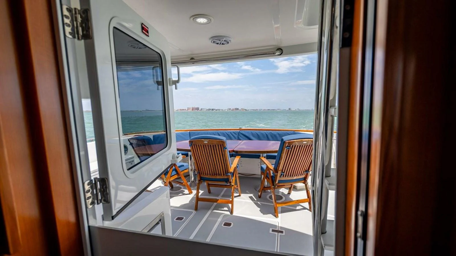 The aft deck offers a serene seating area with a stunning view of the sea. aboard TAKE 5 Yacht for Sale