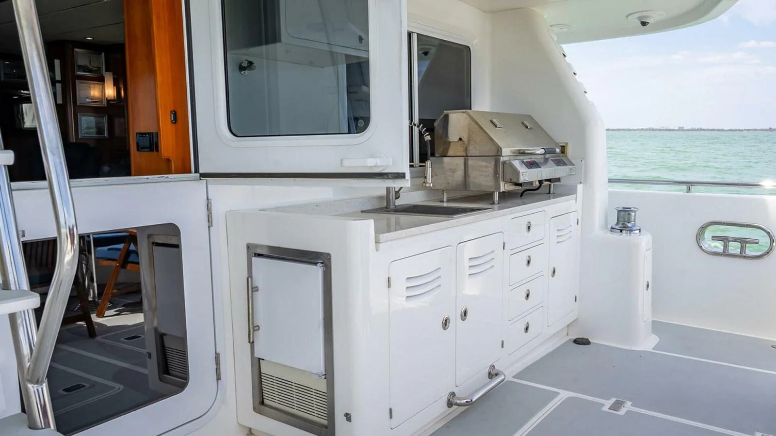 The yacht features a well-equipped outdoor galley with a grill and ample storage, perfect for alfresco dining. aboard TAKE 5 Yacht for Sale