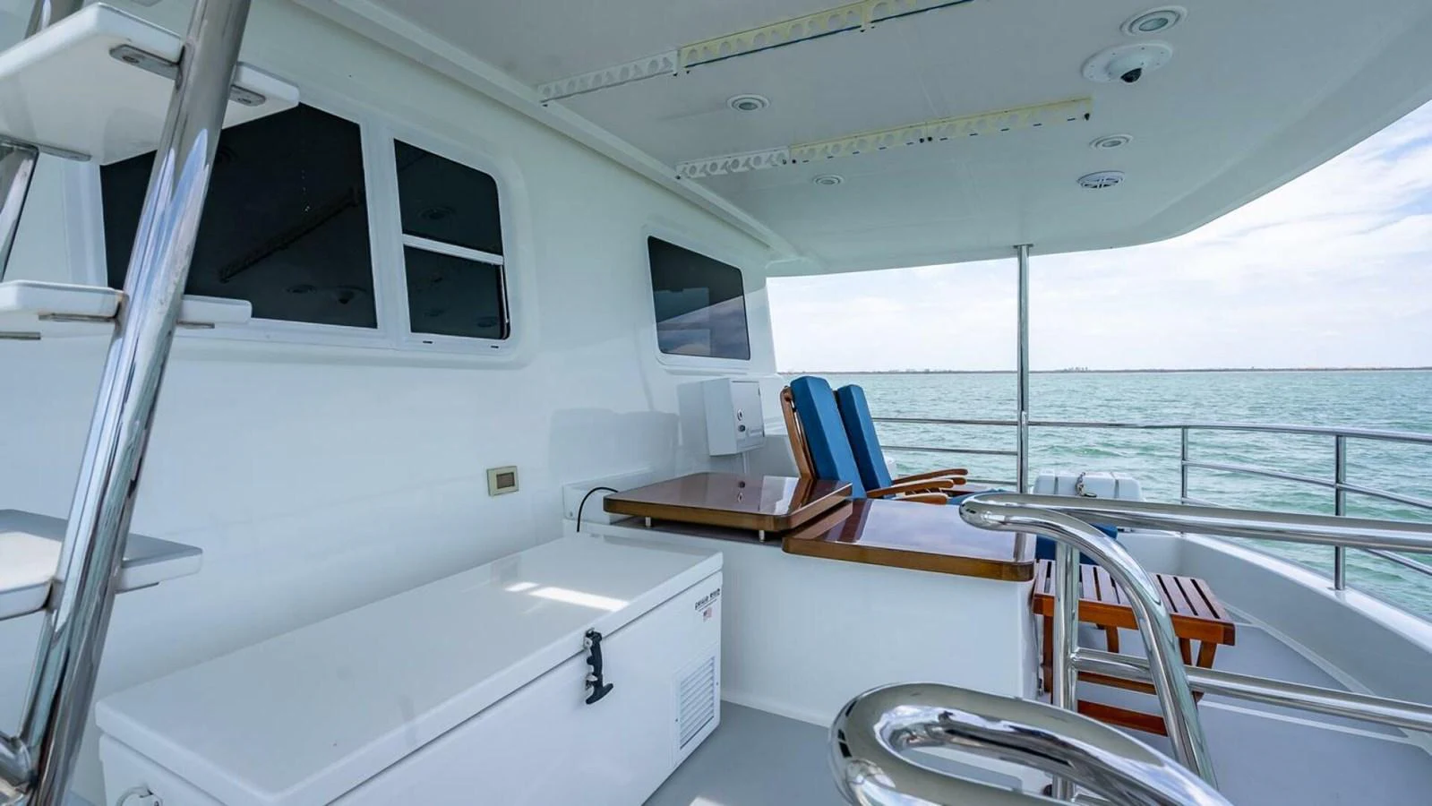The aft deck offers a serene space with seating and a view of the water. aboard TAKE 5 Yacht for Sale