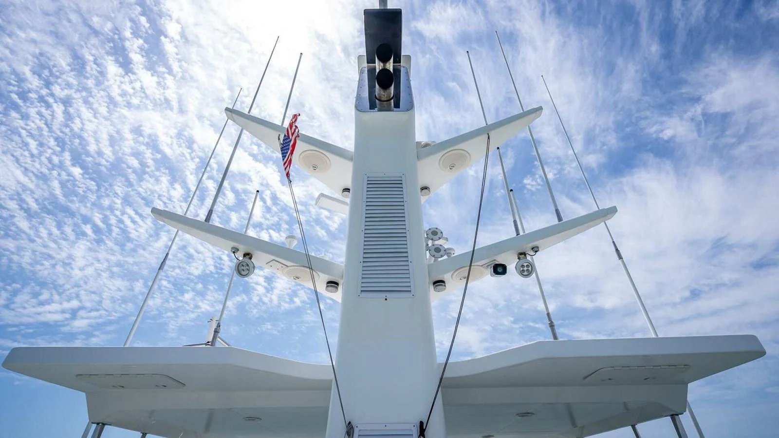 A detailed view of the yacht's mast and communication equipment against a bright, cloudy sky. aboard TAKE 5 Yacht for Sale