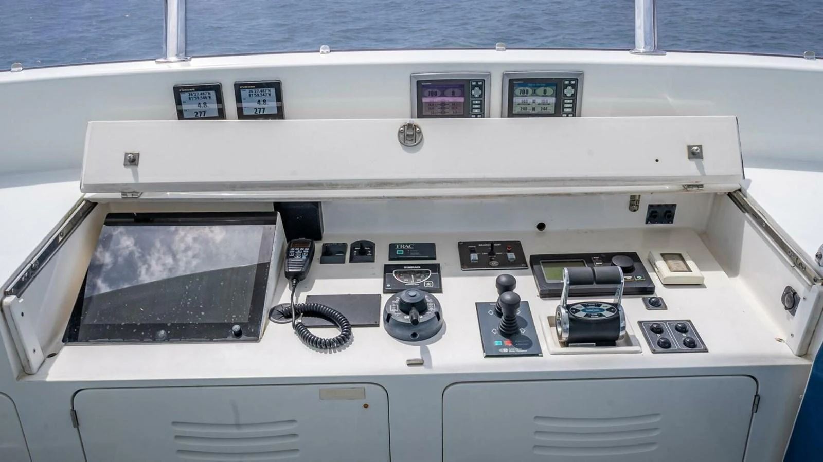 The helm station features advanced navigation and control equipment for seamless yacht operation. aboard TAKE 5 Yacht for Sale