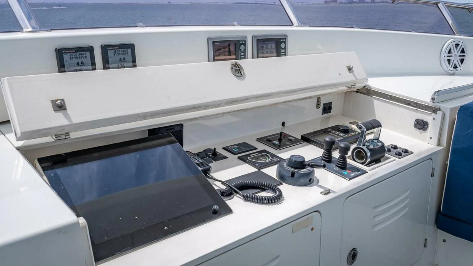 The helm station features advanced navigation and control equipment for seamless yacht operation. aboard TAKE 5 Yacht for Sale