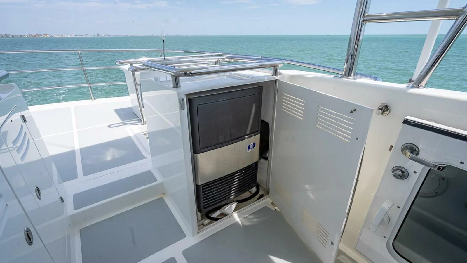 A close-up view of a yacht's outdoor utility area featuring a built-in appliance. aboard TAKE 5 Yacht for Sale