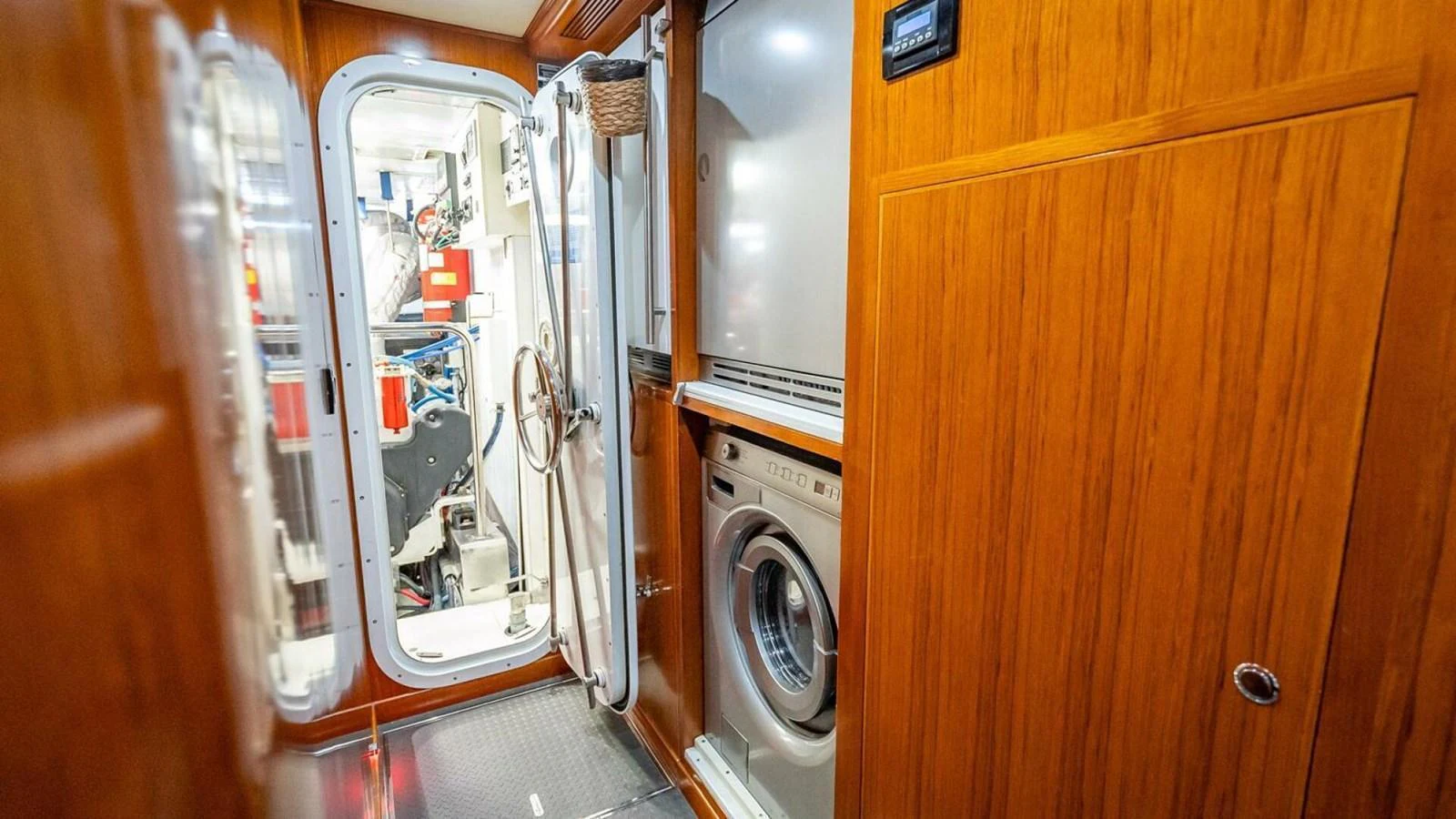 The yacht's interior features a practical laundry area with a washing machine and ample storage space. aboard TAKE 5 Yacht for Sale