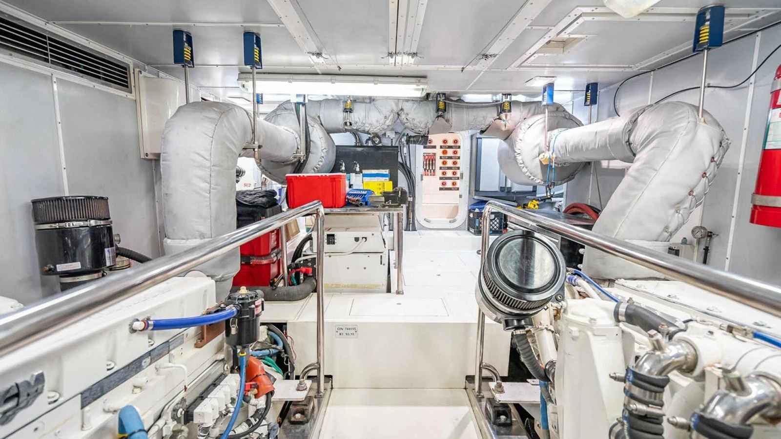 The image showcases the well-maintained engine room of the yacht, highlighting its technical equipment and clean layout. aboard TAKE 5 Yacht for Sale