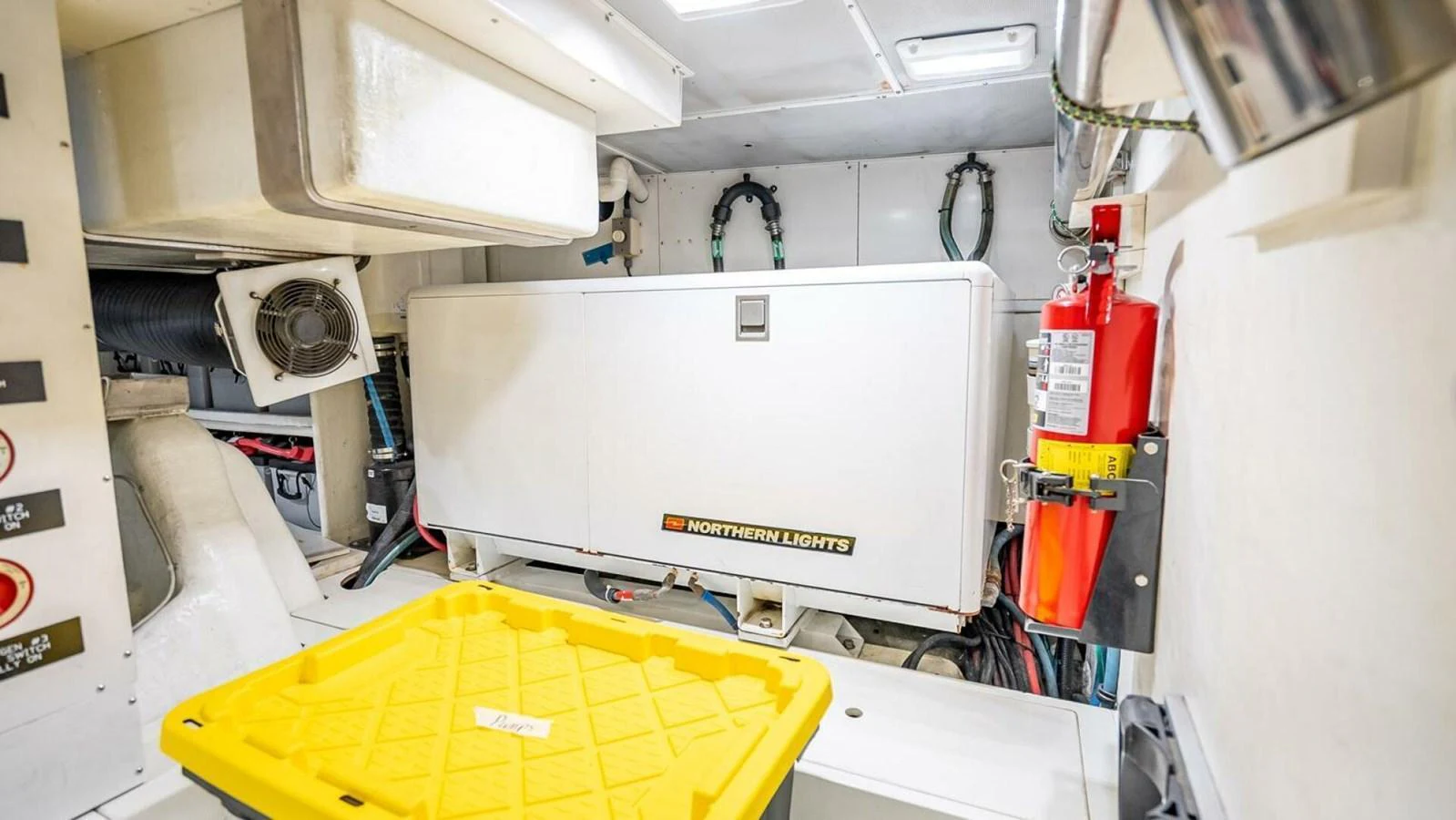 The image showcases the engine room with a generator and various equipment. aboard TAKE 5 Yacht for Sale