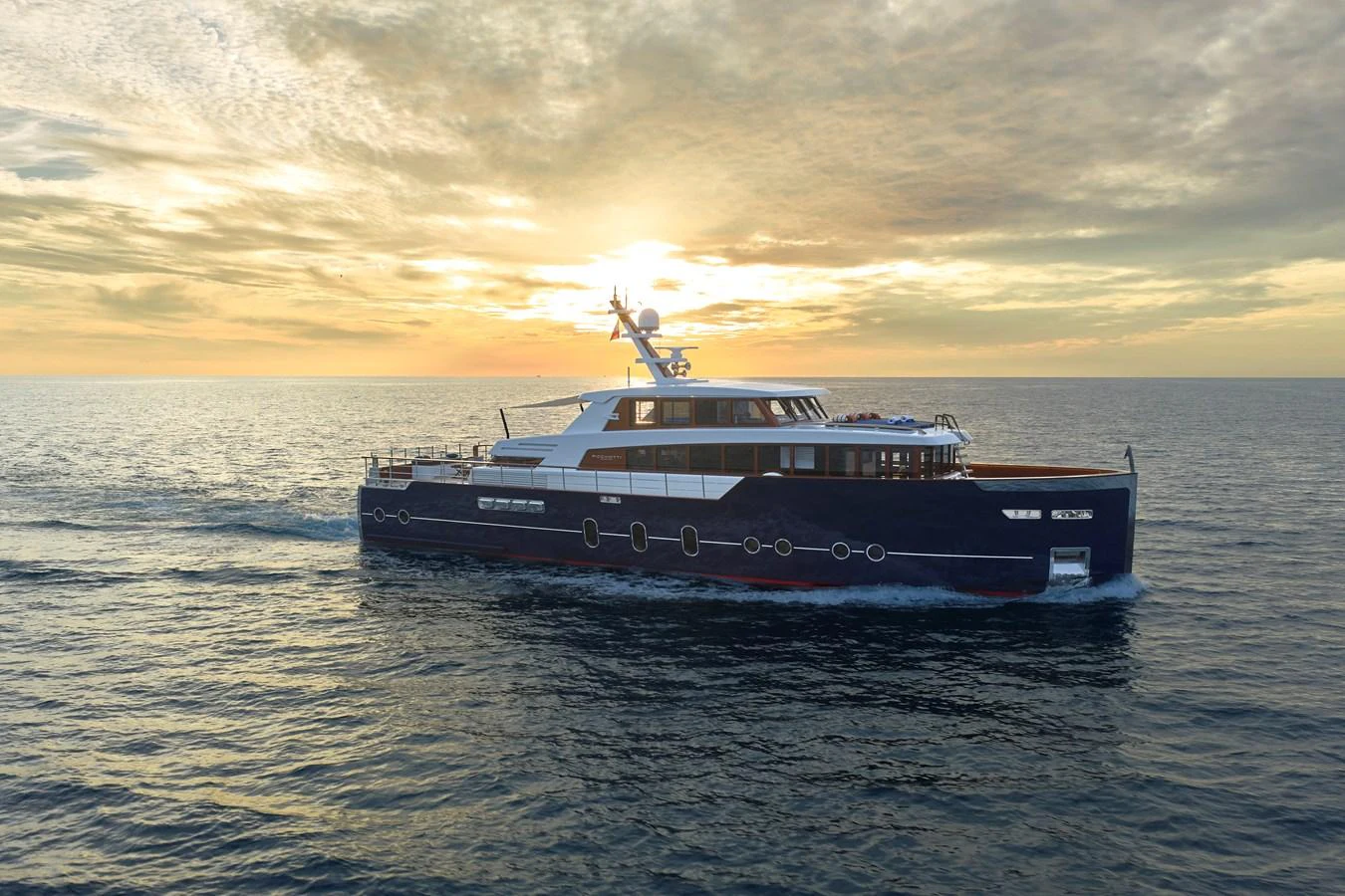 A luxurious yacht cruises through the open sea at sunset, showcasing its elegant design and spacious decks. aboard PICCHIOTTI GENTLEMAN 24 Yacht for Sale