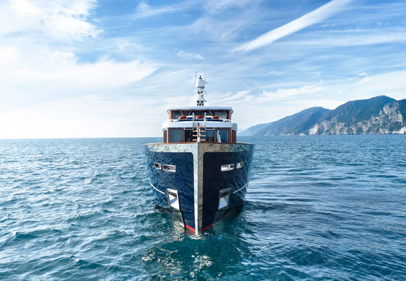 A sleek yacht cruises on the open water with a stunning coastal backdrop. aboard PICCHIOTTI GENTLEMAN 24 Yacht for Sale