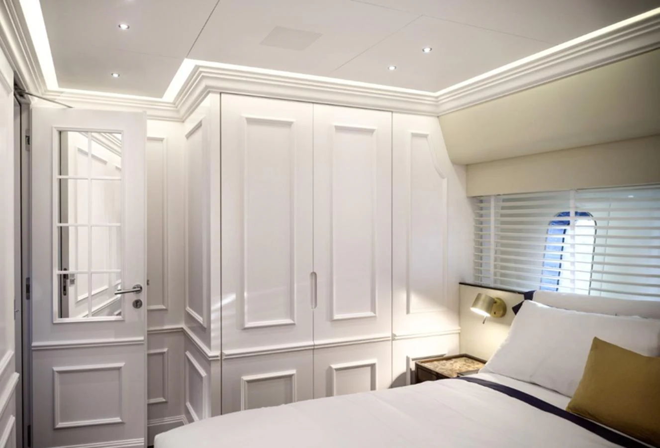 The stateroom features elegant white cabinetry and a comfortable bed, creating a serene and luxurious atmosphere. aboard PICCHIOTTI GENTLEMAN 24 Yacht for Sale