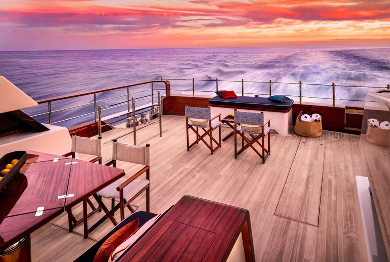 The aft deck offers a serene setting with elegant seating and a stunning ocean view at sunset. aboard PICCHIOTTI GENTLEMAN 24 Yacht for Sale