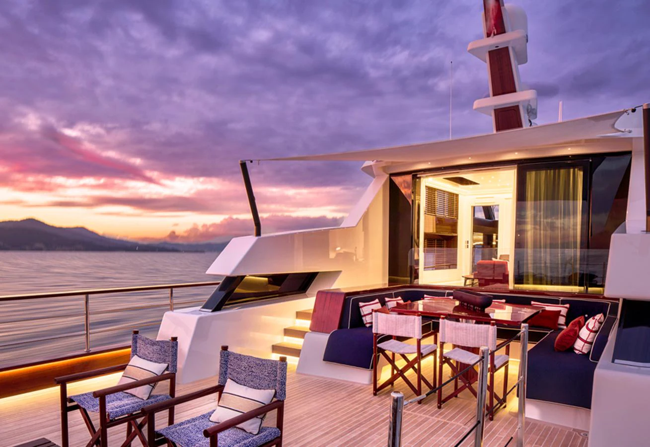 The aft deck offers a luxurious outdoor seating area with a stunning sunset view over the water. aboard PICCHIOTTI GENTLEMAN 24 Yacht for Sale