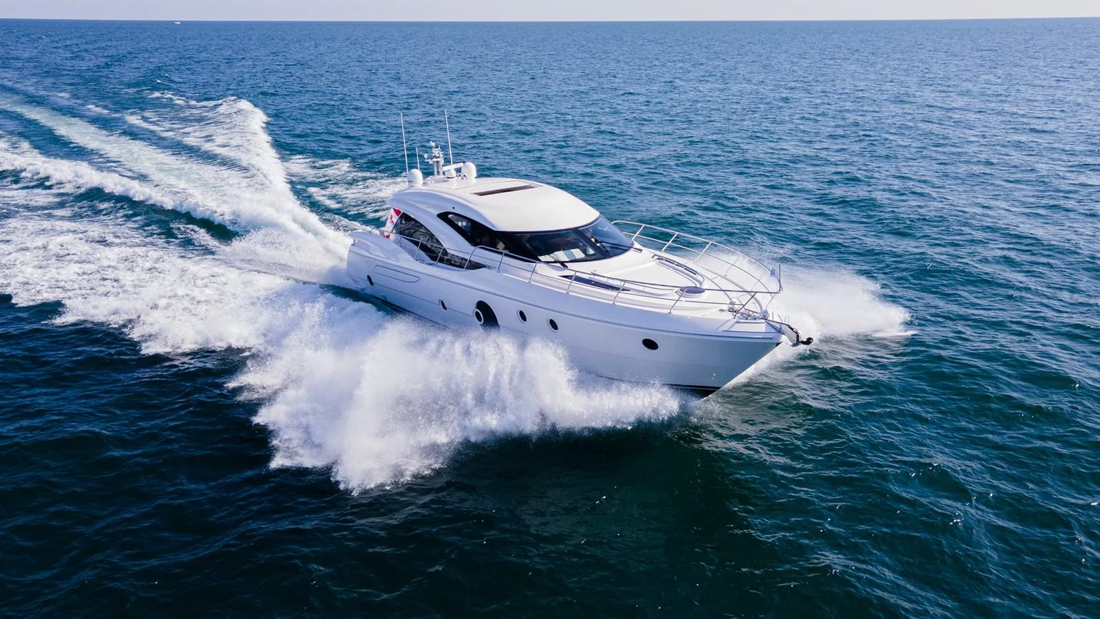A sleek yacht cruises swiftly through the open sea, showcasing its elegant design and powerful performance. aboard NEPTUNUS 650E Yacht for Sale