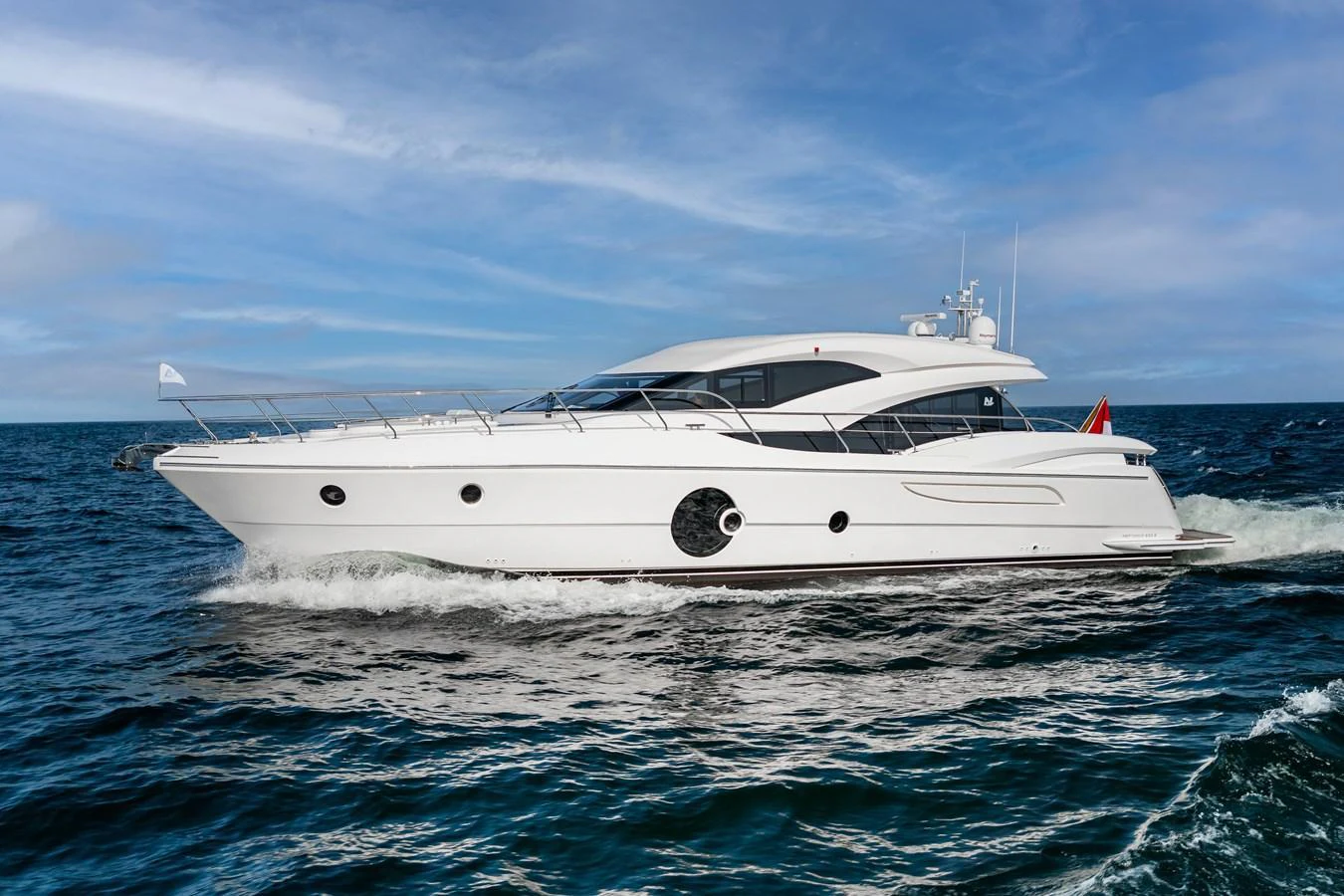 A sleek and modern yacht cruises smoothly on the open water under a clear blue sky. aboard NEPTUNUS 650E Yacht for Sale