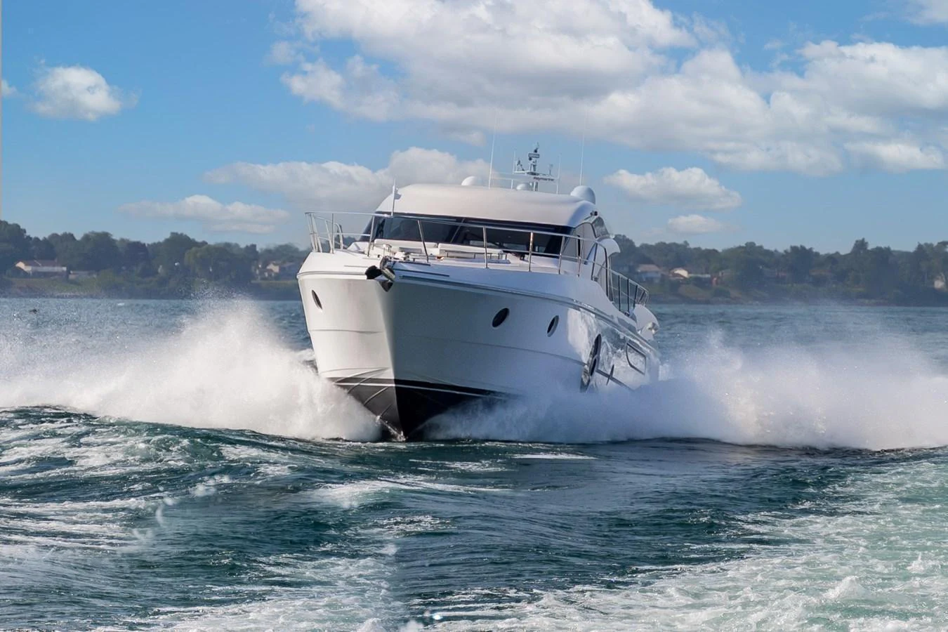 A sleek yacht cuts through the water at high speed, creating an impressive wake. aboard NEPTUNUS 650E Yacht for Sale