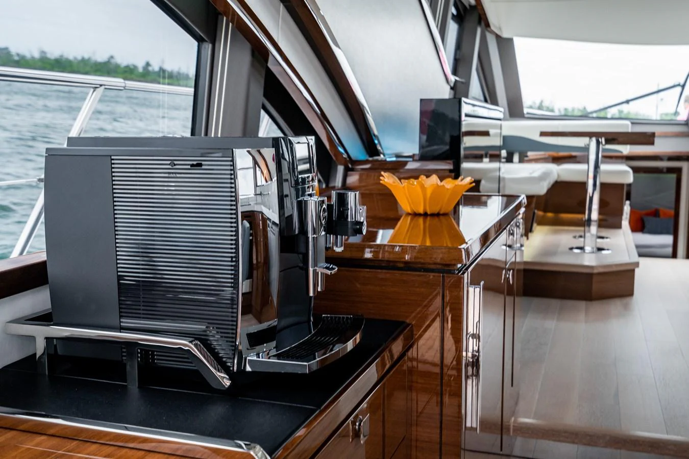 The yacht's galley features modern appliances and elegant wood cabinetry. aboard NEPTUNUS 650E Yacht for Sale