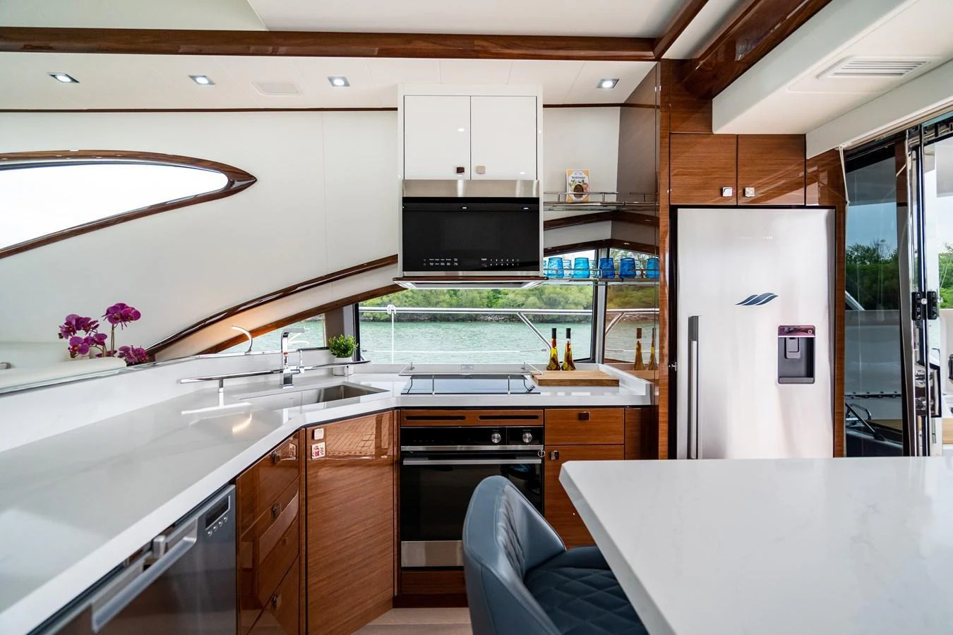 The yacht's galley features modern appliances and a sleek design with ample natural light. aboard NEPTUNUS 650E Yacht for Sale