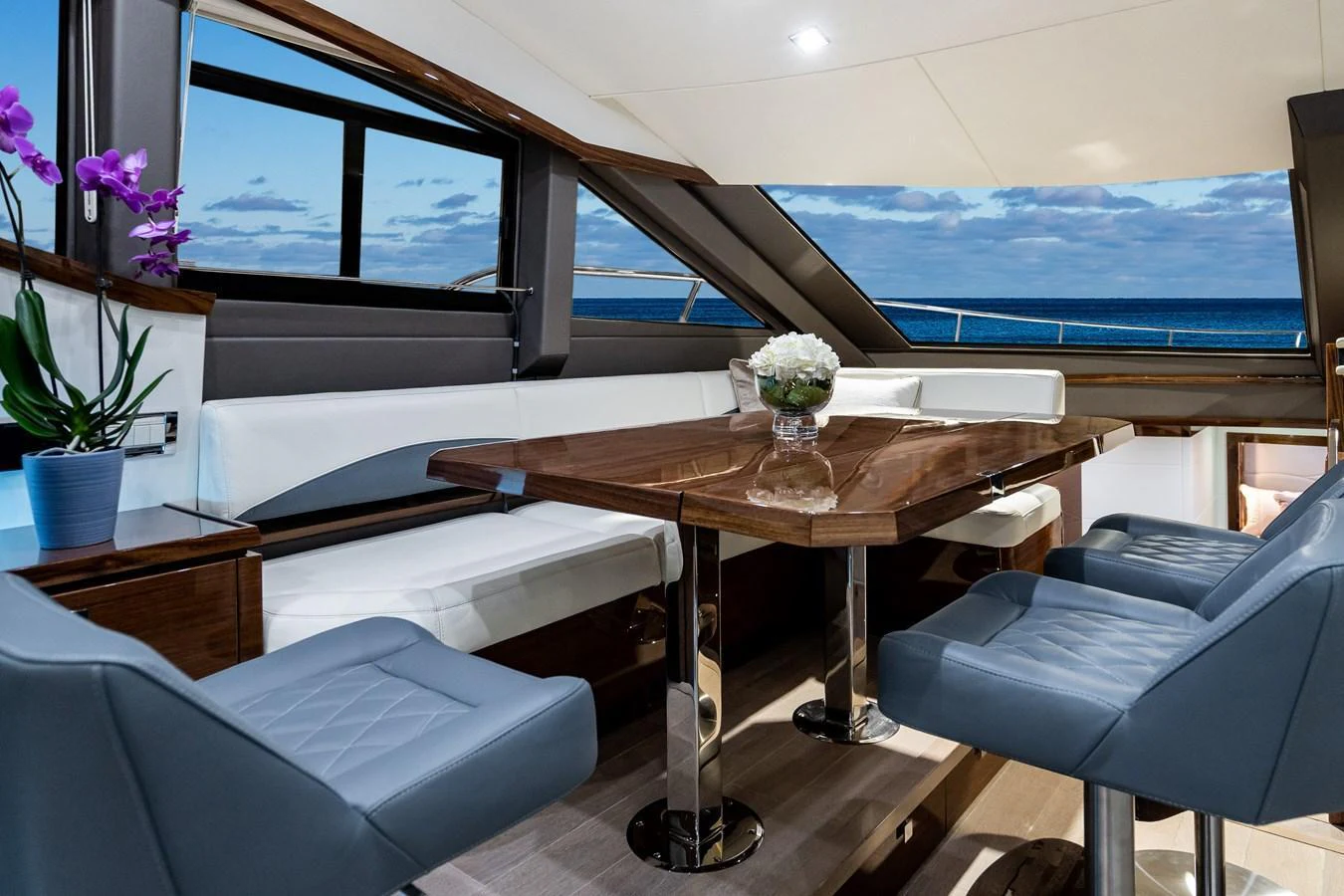 The yacht's dining area offers a luxurious and modern setting with ocean views. aboard NEPTUNUS 650E Yacht for Sale