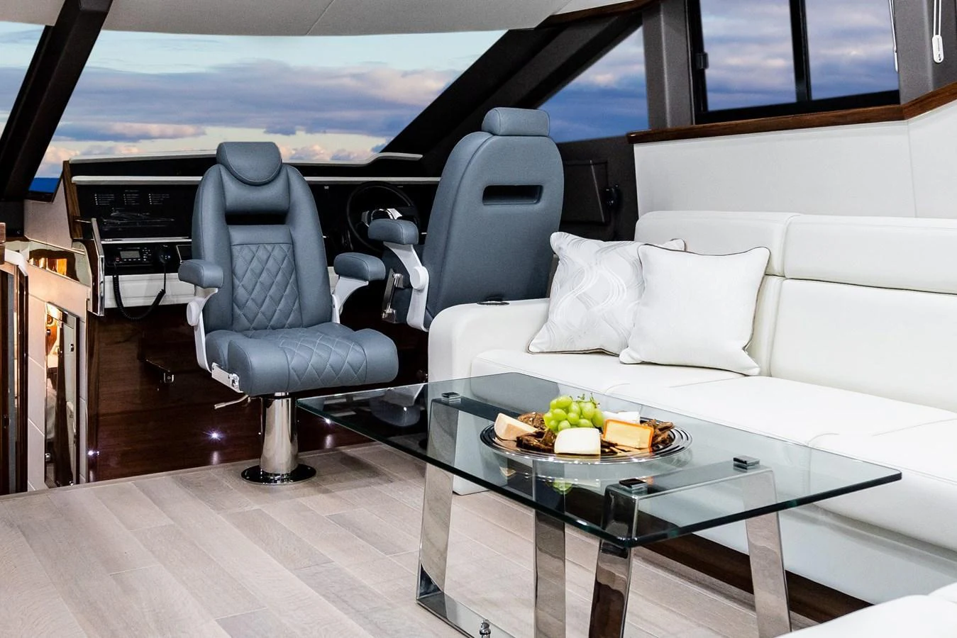 The salon features luxurious seating and a modern helm station with panoramic views. aboard NEPTUNUS 650E Yacht for Sale