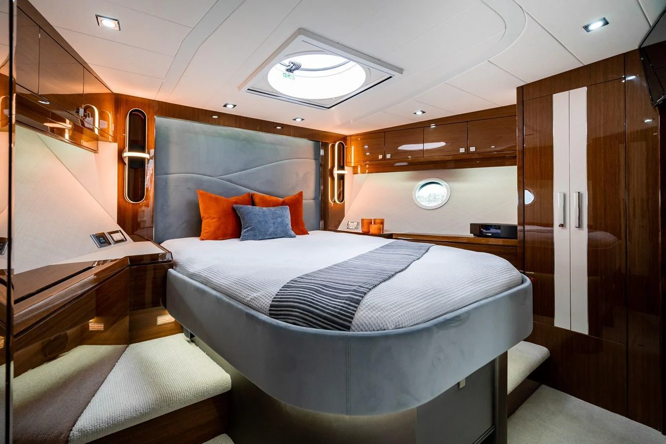 The stateroom features a luxurious bed with elegant bedding and ambient lighting, creating a cozy and sophisticated atmosphere. aboard NEPTUNUS 650E Yacht for Sale