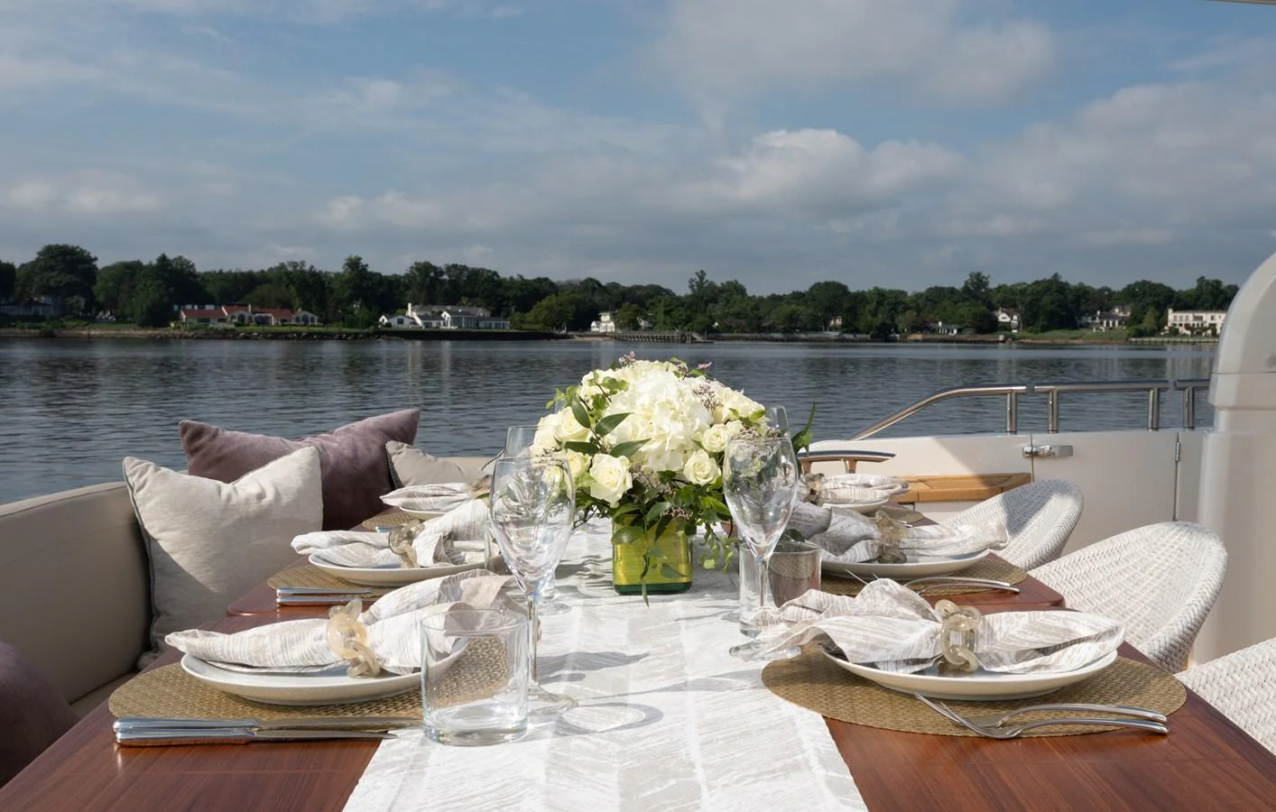 a table with plates and glasses on it aboard JUST PERFECT Yacht for Sale