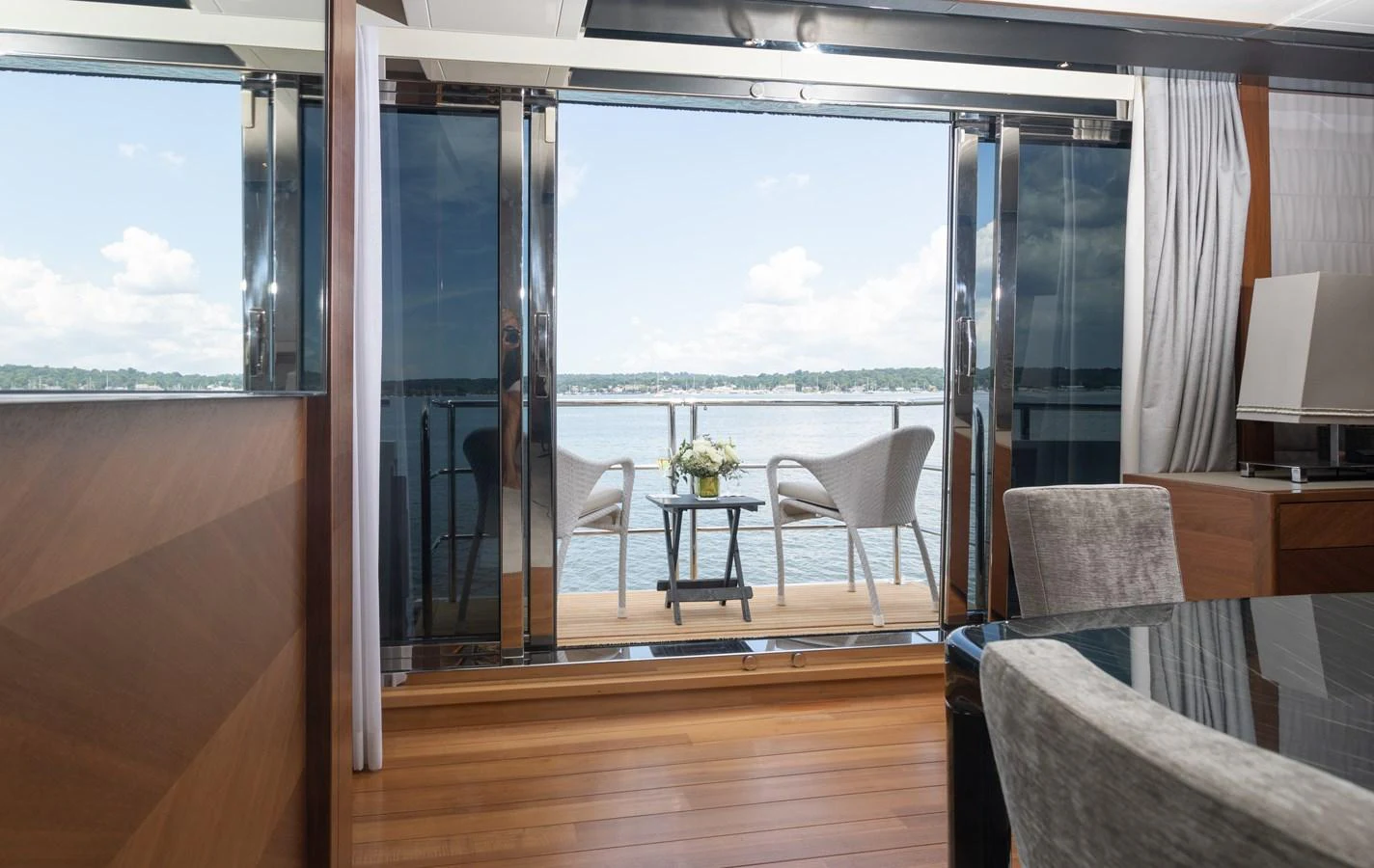 a room with a table chairs and a window aboard JUST PERFECT Yacht for Sale