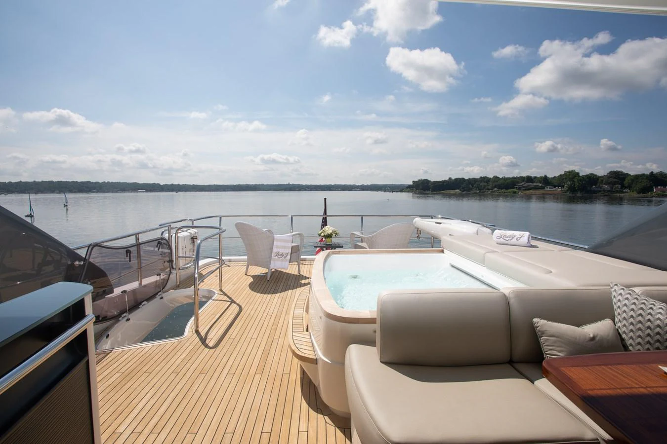 a deck with a large body of water and a large boat in the background aboard JUST PERFECT Yacht for Sale