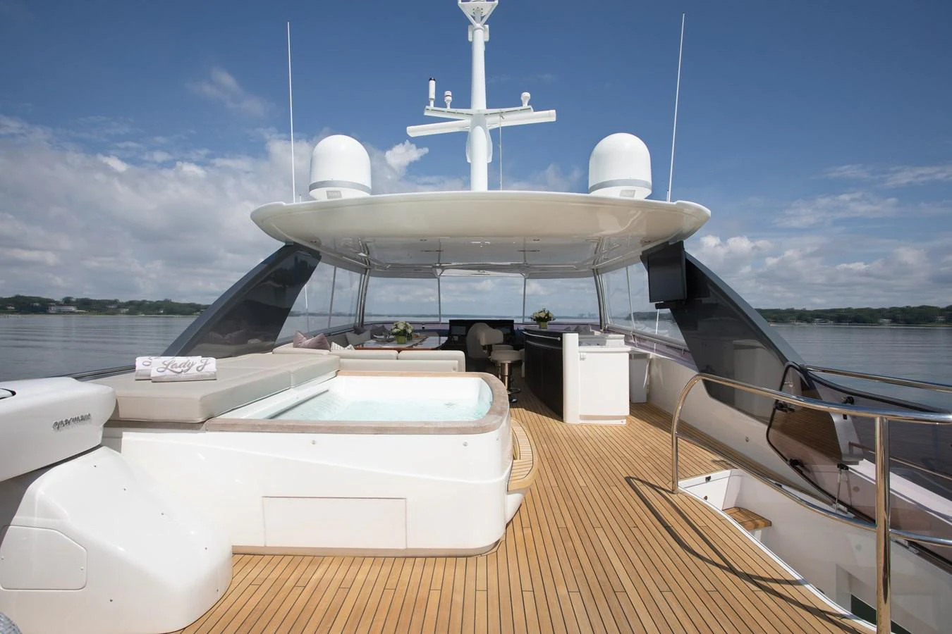 a deck with a large white ship on it and a white windmill in the background aboard JUST PERFECT Yacht for Sale