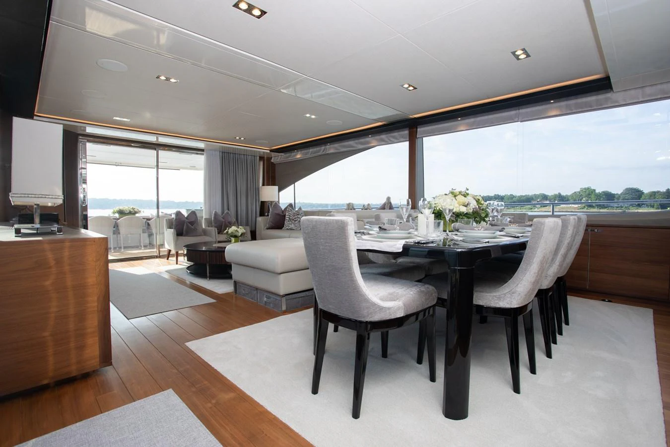 a large room with a table and chairs aboard JUST PERFECT Yacht for Sale