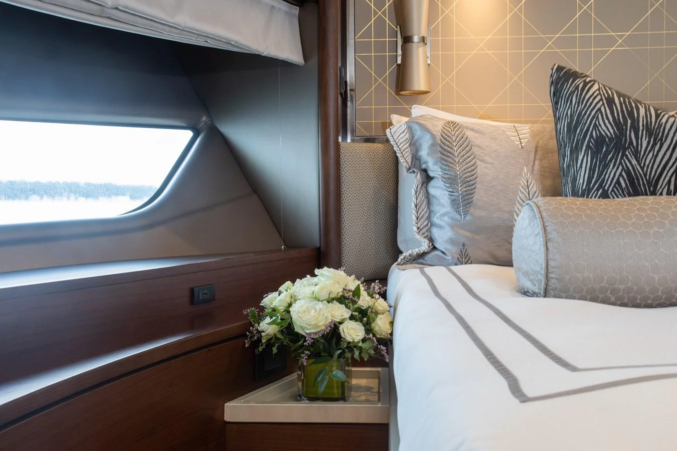a room with a couch and a vase of flowers aboard JUST PERFECT Yacht for Sale