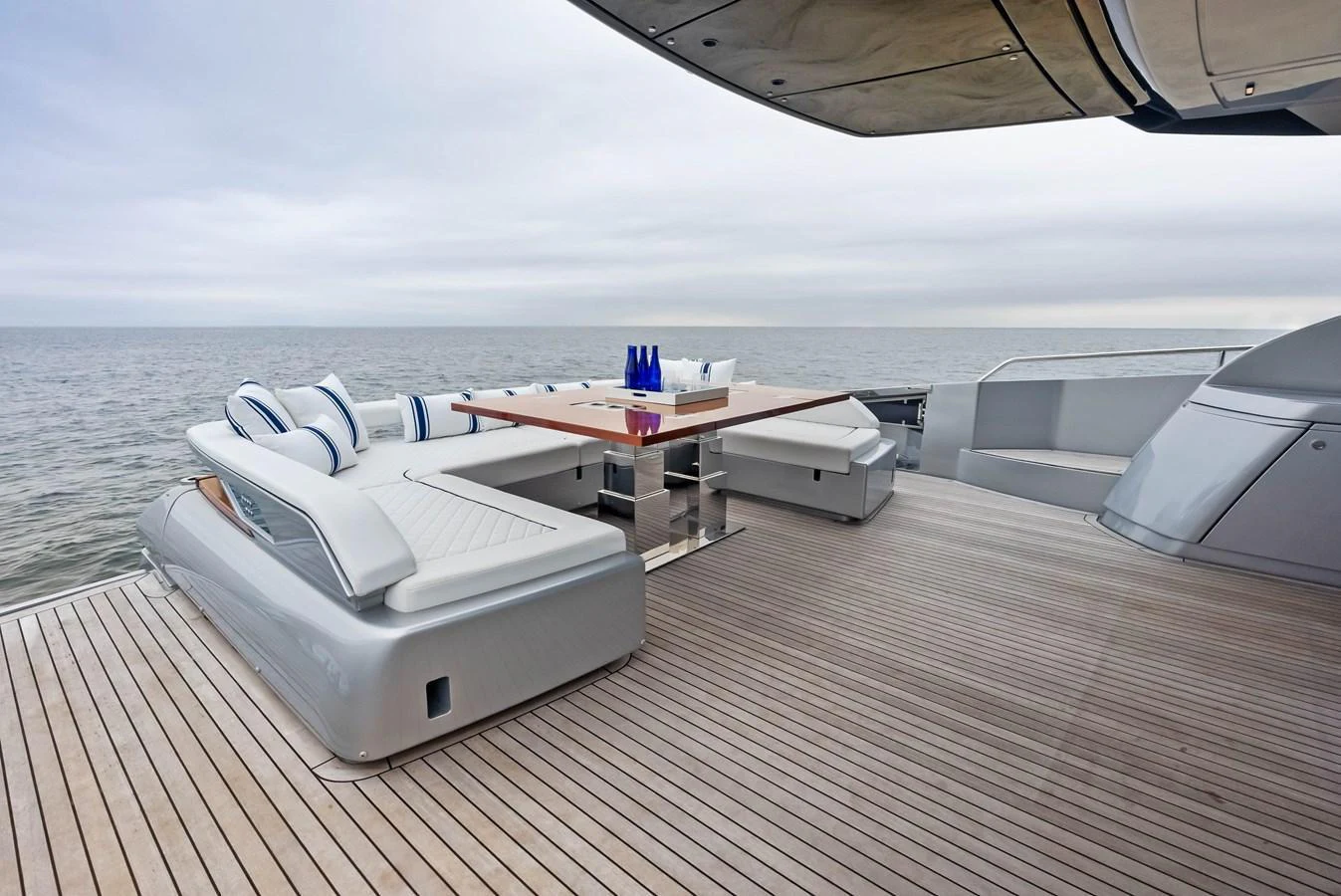 The aft deck features a stylish seating area with a sleek dining table, offering a perfect spot for relaxation and ocean views. aboard FERRETTI  TRADE Yacht for Sale