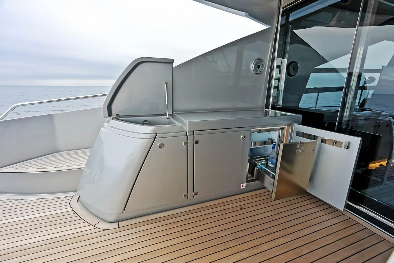 The yacht features a sleek outdoor galley with modern stainless steel appliances and ample counter space. aboard FERRETTI  TRADE Yacht for Sale
