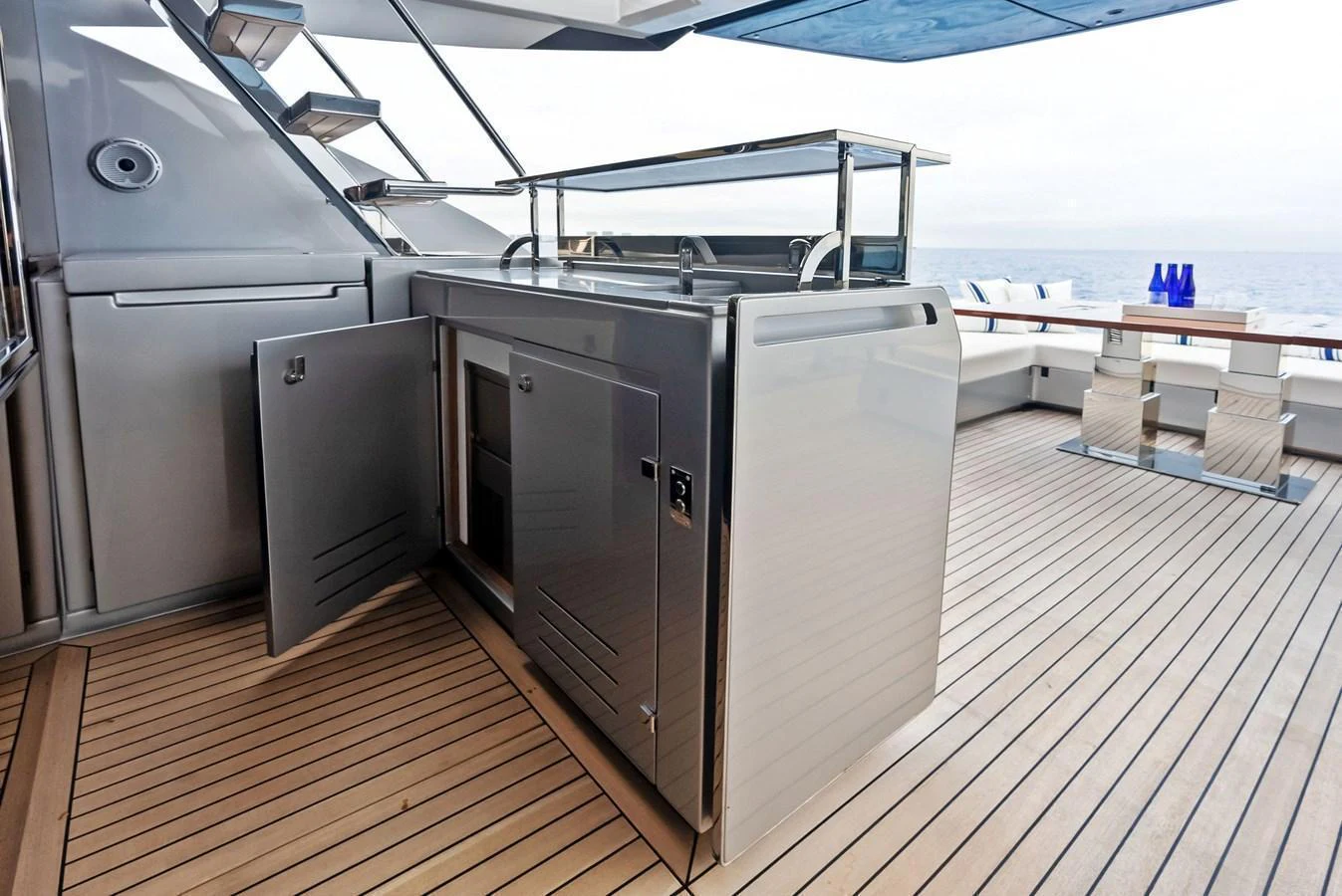 The yacht features a sleek outdoor galley with stainless steel appliances and a spacious deck area for entertaining. aboard FERRETTI  TRADE Yacht for Sale