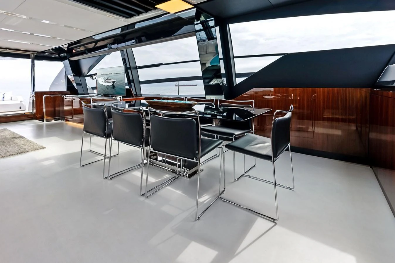 The yacht's dining area features sleek, modern furnishings with expansive windows offering stunning ocean views. aboard FERRETTI  TRADE Yacht for Sale