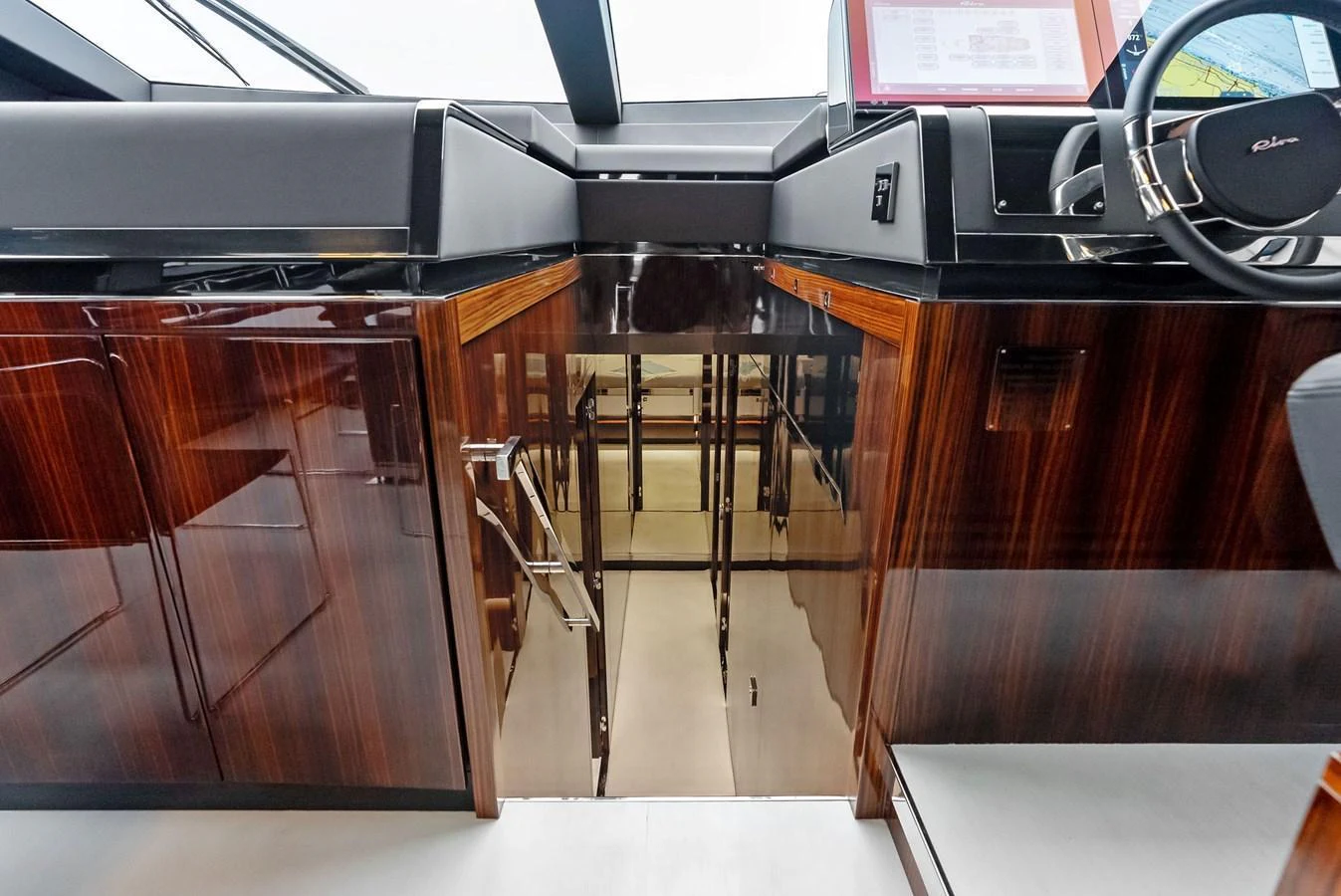 The helm station features sleek, modern design with high-gloss wood finishes and advanced navigation equipment. aboard FERRETTI  TRADE Yacht for Sale