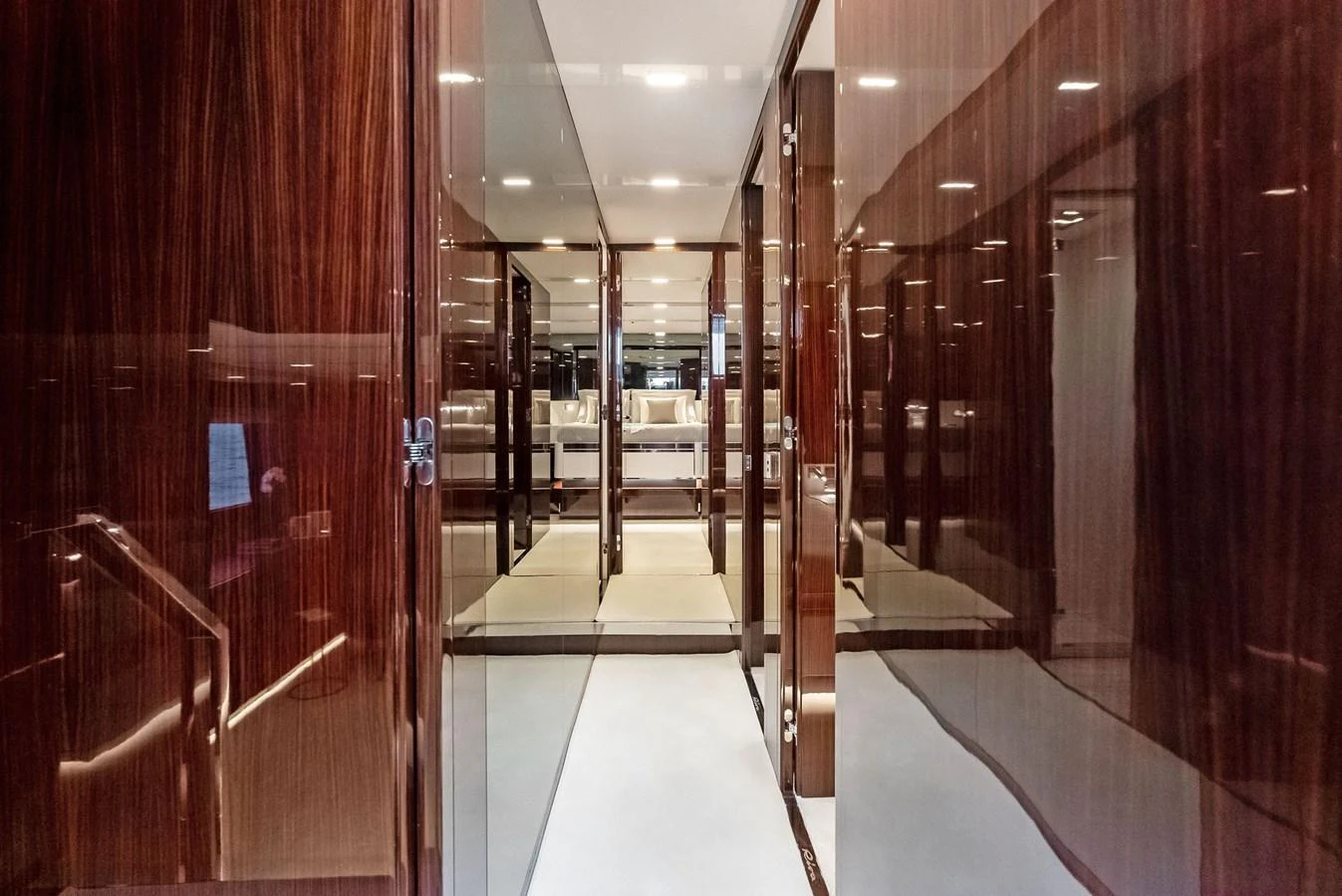 The image showcases a luxurious yacht interior corridor with high-gloss wooden paneling and modern lighting. aboard FERRETTI  TRADE Yacht for Sale
