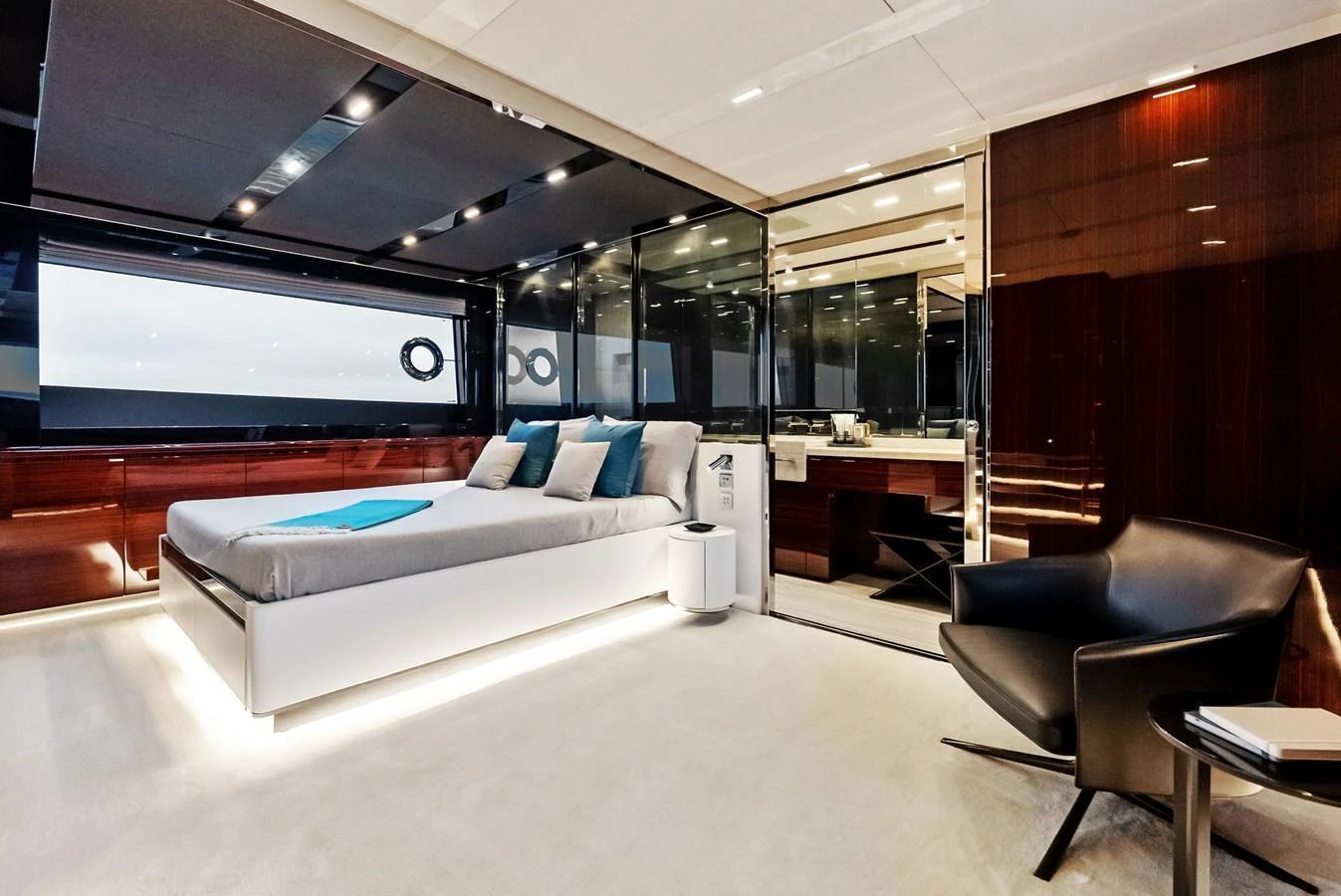 The master stateroom features a luxurious bed, sleek furnishings, and modern lighting. aboard FERRETTI  TRADE Yacht for Sale