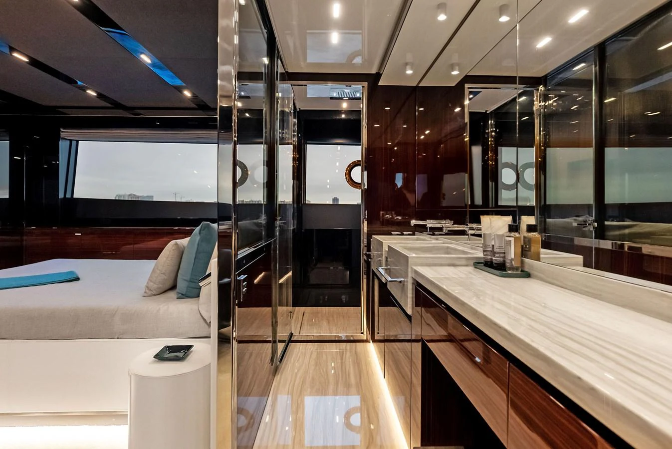 The yacht's stateroom features a luxurious bed, sleek cabinetry, and elegant lighting. aboard FERRETTI  TRADE Yacht for Sale