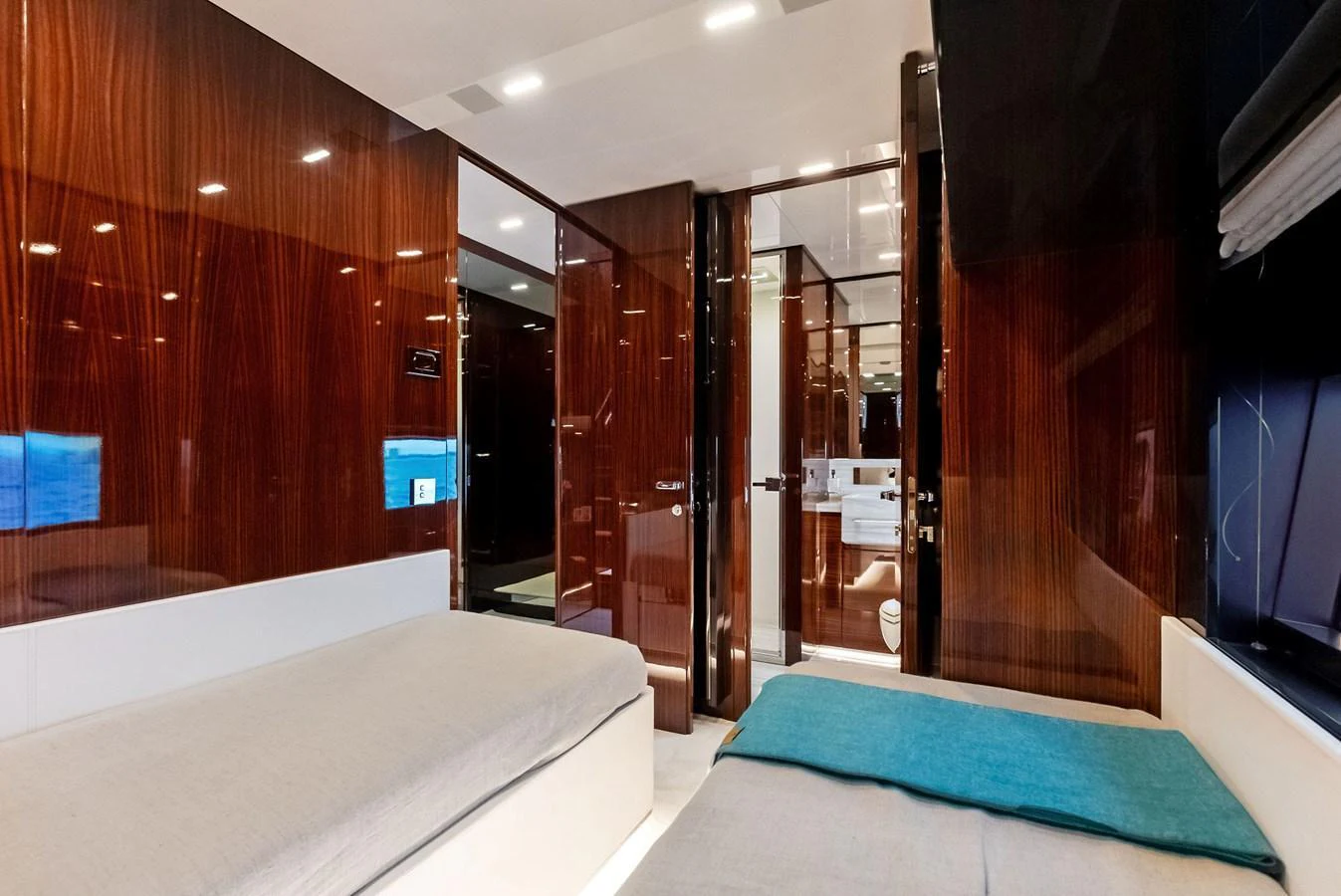 A luxurious stateroom with twin beds and high-gloss wooden finishes. aboard FERRETTI  TRADE Yacht for Sale