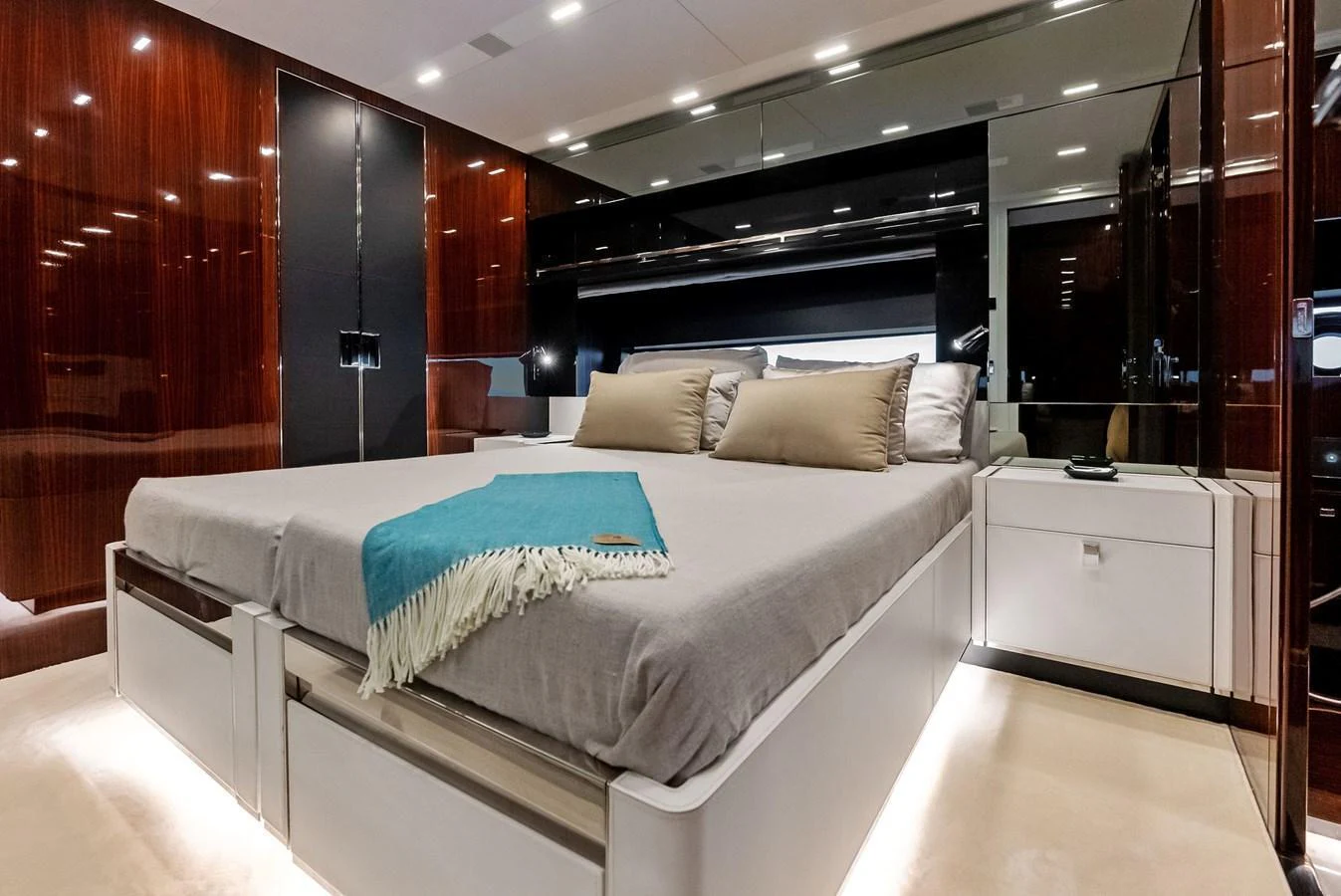 The master stateroom features a luxurious bed with elegant wood paneling and modern lighting. aboard FERRETTI  TRADE Yacht for Sale