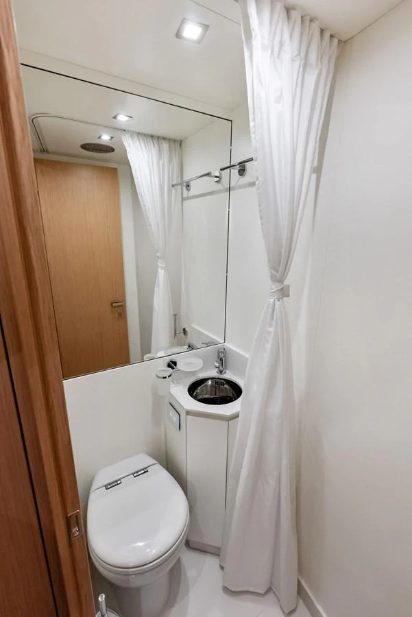 A compact and modern yacht bathroom with sleek fixtures and a clean design. aboard FERRETTI  TRADE Yacht for Sale