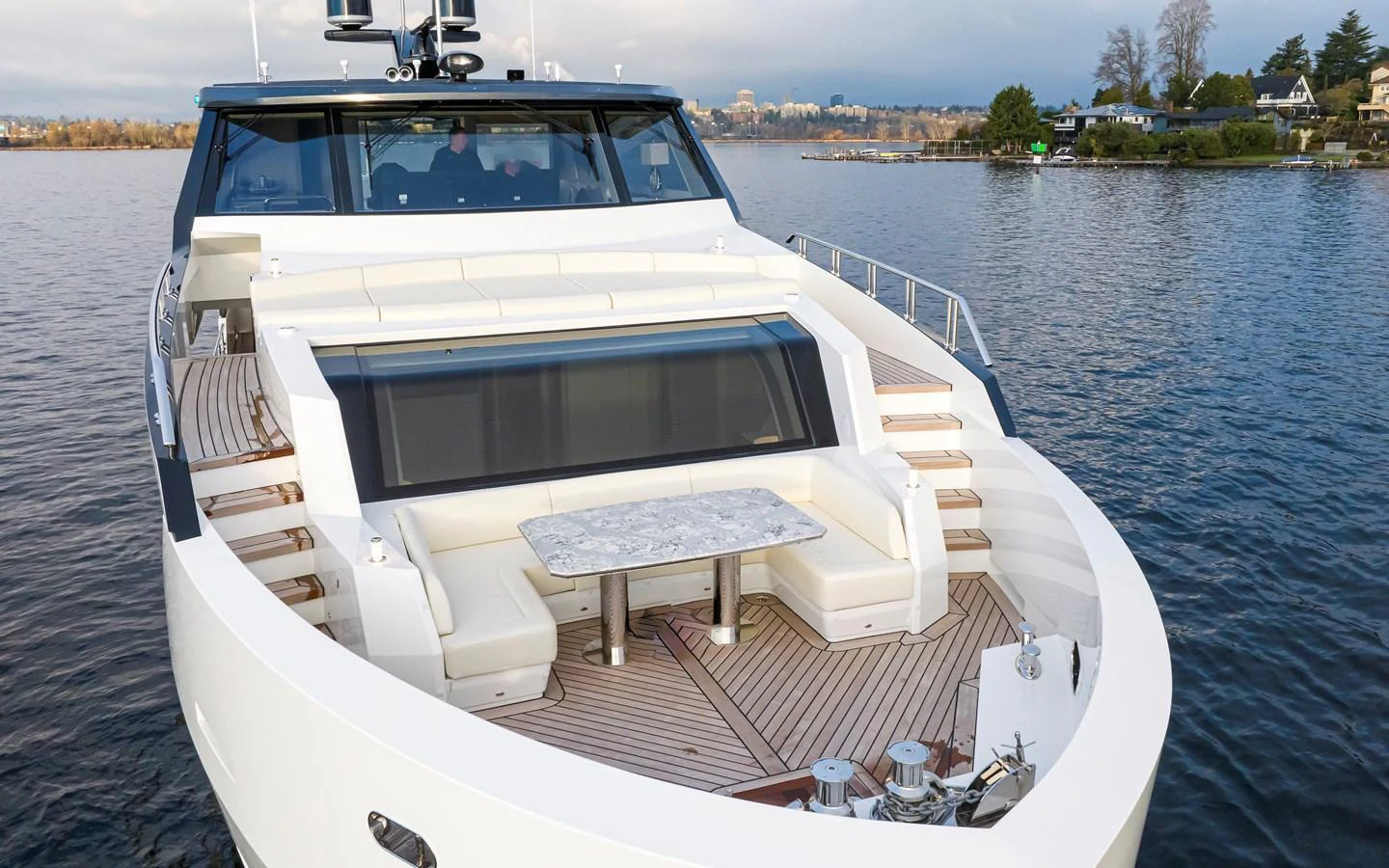 The yacht's bow features a spacious seating area with a central table, perfect for outdoor relaxation and dining. aboard STILL WATERS Yacht for Sale