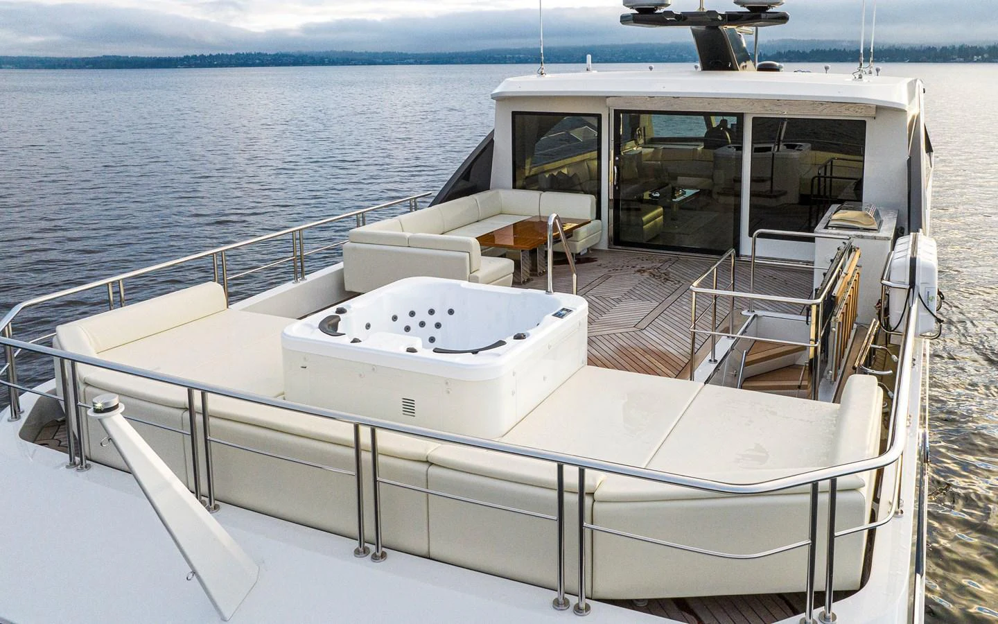 The yacht's aft deck features a luxurious hot tub and ample seating for relaxation. aboard STILL WATERS Yacht for Sale
