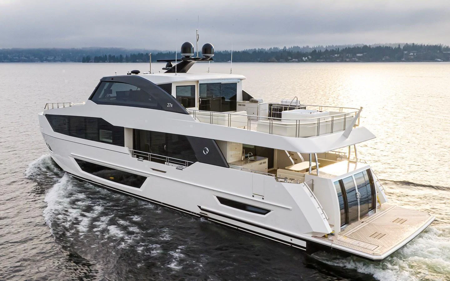 A sleek and modern yacht cruises through calm waters, showcasing its spacious deck and elegant design. aboard STILL WATERS Yacht for Sale