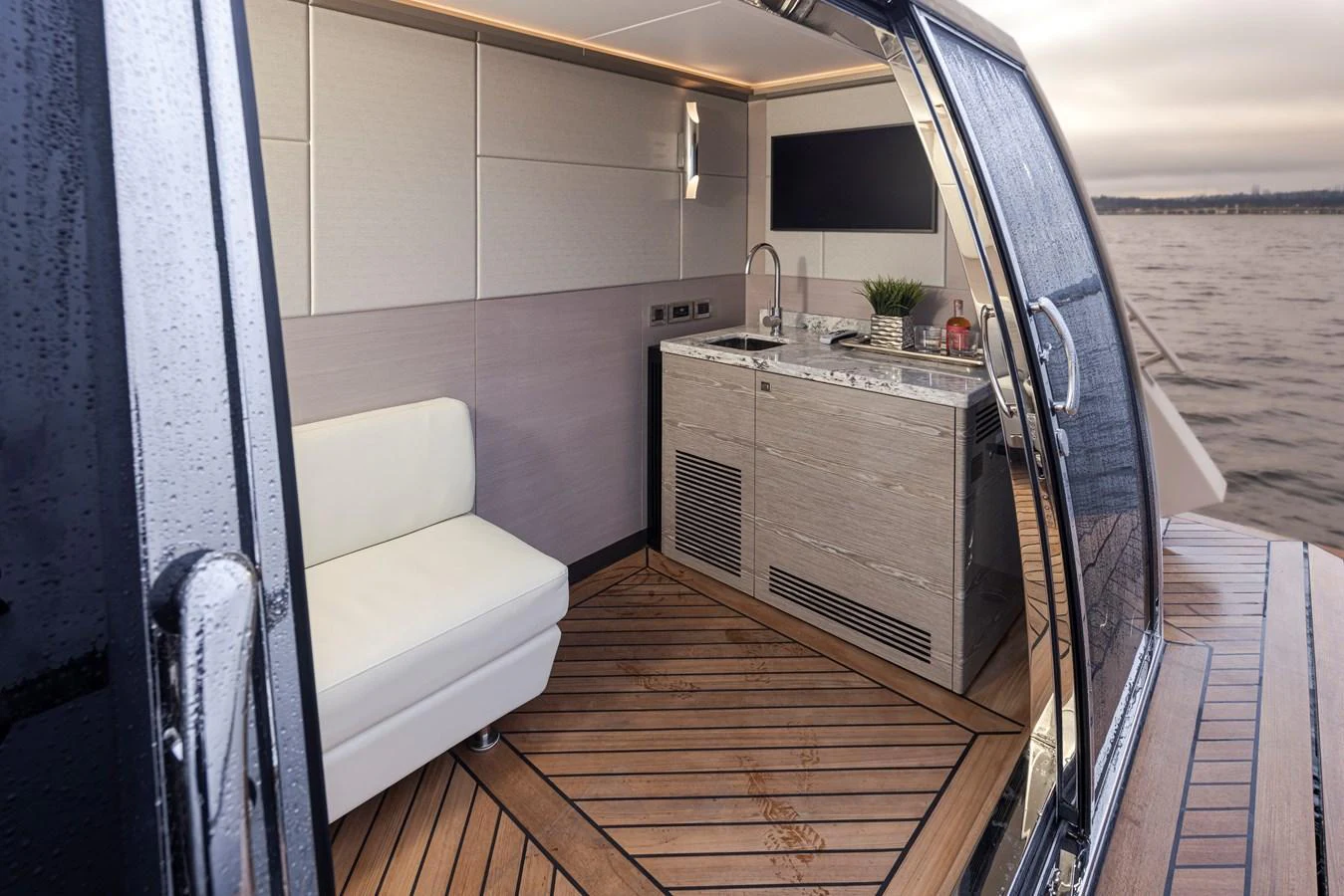 A sleek galley area with modern amenities and a comfortable seating arrangement, overlooking the water. aboard STILL WATERS Yacht for Sale