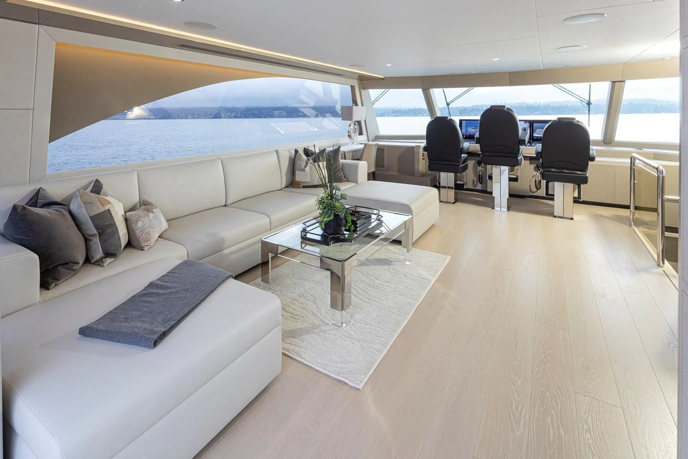 The salon features a spacious seating area with modern furnishings and panoramic windows offering stunning views. aboard STILL WATERS Yacht for Sale