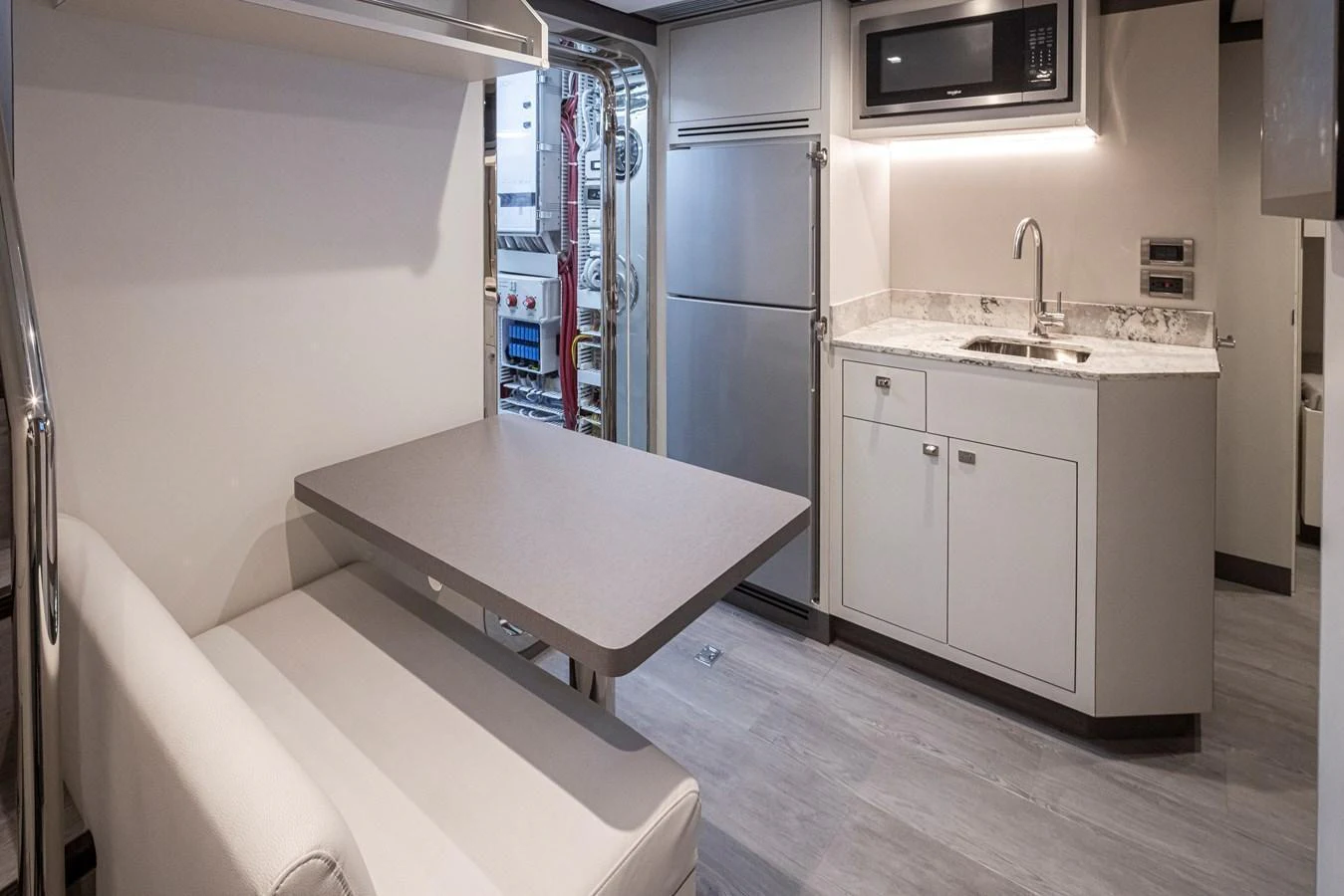 The yacht's galley features modern appliances and a cozy dining nook. aboard STILL WATERS Yacht for Sale