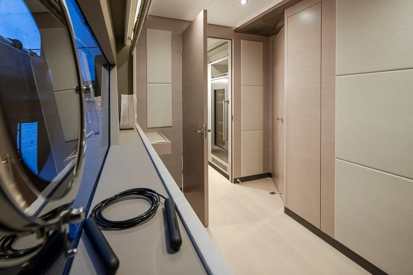 The interior hallway features modern design with sleek cabinetry and ample lighting. aboard STILL WATERS Yacht for Sale