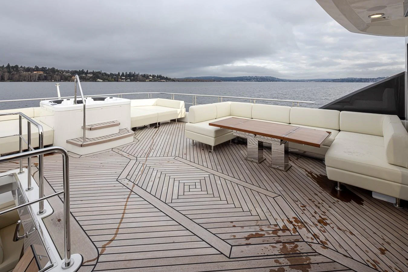 The aft deck features spacious seating and a stylish table, perfect for outdoor relaxation and dining. aboard STILL WATERS Yacht for Sale