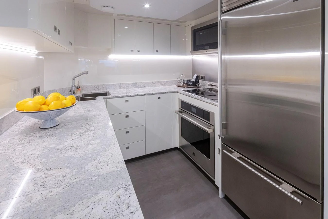 The yacht's galley features modern appliances and a sleek, minimalist design. aboard STILL WATERS Yacht for Sale