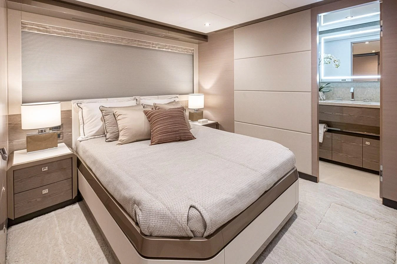 The stateroom features a luxurious bed with elegant bedding and modern lighting. aboard STILL WATERS Yacht for Sale